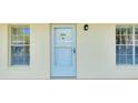 Charming unit entrance featuring a storm door, windows, and bright exterior lighting at 1018 Wexford Blvd # 1018, Venice, FL 34293