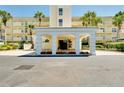 Inviting building entrance with colorful flowers and tropical palm trees creates a warm welcome at 1018 Wexford Blvd # 1018, Venice, FL 34293