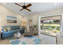 Cozy living room with comfortable seating and serene views of the golf course at 1025 Capri Isles Blvd # 18, Venice, FL 34292