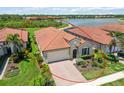 Beautiful home with tile roof, attached garage, brick driveway, and lovely landscaping in quiet neighborhood at 10618 Corkwood Ct, Venice, FL 34293