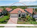 Charming single-story home with a tile roof, brick driveway, and lush front yard in a peaceful neighborhood at 10618 Corkwood Ct, Venice, FL 34293