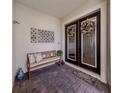 Covered porch featuring double doors, a bench, and decor at 10973 Trevino St, Englewood, FL 34223