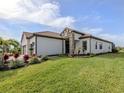 A well-manicured lawn surrounds this home's exterior at 10973 Trevino St, Englewood, FL 34223
