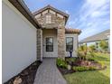 This home has a stone facade and a covered entryway at 10973 Trevino St, Englewood, FL 34223