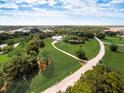A long driveway approaches the home with sprawling lawn and plentiful trees, all of which make this a picturesque property at 1104 Twin Laurel Blvd, Nokomis, FL 34275