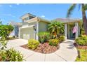 Beautiful single-story home with a well-manicured lawn and landscaping, along with a two-car garage at 12478 Sagewood Dr, Venice, FL 34293