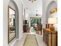 Inviting entryway with tiled flooring, arched doorways, and a view into the spacious living room at 129 Preserve Pl # D, Nokomis, FL 34275