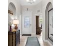Welcoming entryway with tiled flooring, arched doorways, and decorative accents at 129 Preserve Pl # D, Nokomis, FL 34275