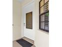 Elegant front door with decorative glass insert and sleek hardware providing a warm welcome to the home at 129 Preserve Pl # D, Nokomis, FL 34275