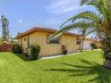 Well-manicured lawn and charming home with decorative shutters at 1320 Whispering Ln, Venice, FL 34285
