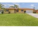 Lovely home with a large lawn and attached two-car garage at 1320 Whispering Ln, Venice, FL 34285