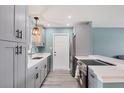 Beautiful kitchen featuring sleek gray cabinets, modern appliances, and ample countertop space, perfect for cooking at 13579 Romford Ave, Port Charlotte, FL 33981