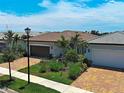 A nice residential area with attractive homes, palm trees, well-maintained lawns, and tidy landscaping at 13731 Vadini St, Venice, FL 34293
