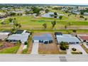 An aerial view of the property near a golf course, revealing the home's location in a serene neighborhood at 144 Rotonda Cir, Rotonda West, FL 33947