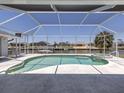 The screened-in pool area offers a jacuzzi and scenic water views, perfect for relaxation and entertainment at 15448 Avery Rd, Port Charlotte, FL 33981