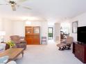 Bright and airy living room with plush carpeting and comfortable furnishings at 1566 Tallywood Dr # 7125, Sarasota, FL 34237