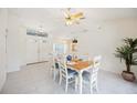 Bright dining area with tile floors, white furniture, and adjacent to the living room at 1568 Ringtail Rd, Venice, FL 34293