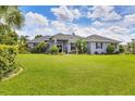 Beautiful front yard features mature landscaping and a well-maintained lawn for curb appeal at 2000 Jasmine Way, North Port, FL 34287