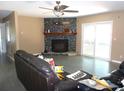 Large living room featuring a decorative tiled fireplace and neutral colored walls at 2682 Yamada Ln, North Port, FL 34286