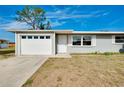 A well maintained single-story home featuring a garage and a neatly kept lawn at 2980 Siesta Dr, Venice, FL 34293