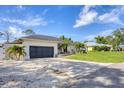 Home featuring an attached garage and a long concrete driveway at 307 Bucknell Rd, Venice, FL 34293