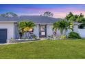 Inviting front entrance with lush landscaping and a well-manicured lawn at 307 Bucknell Rd, Venice, FL 34293