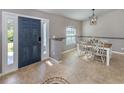 Inviting foyer with tile floors, decorative inlay, and a view into the dining area with a pendant light at 3255 Tally Ho Rd # 1, North Port, FL 34291