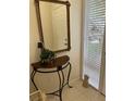 Elegant entryway with a decorative table, mirror, and view to outside at 406 Laurel Lake Dr # 103, Venice, FL 34292