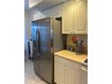 Modern stainless steel refrigerator complemented by white cabinets and countertops at 406 Laurel Lake Dr # 103, Venice, FL 34292