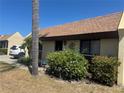 Inviting single-story home with a well-kept lawn, framed by a mature palm tree at 469 Albee Farm Rd # V19, Venice, FL 34285