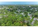Aerial view of a house nestled amongst lush greenery and other homes at 5106 S Lockwood Ridge Rd, Sarasota, FL 34231