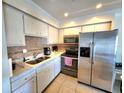 Updated kitchen featuring stainless steel appliances and bright cabinetry at 525 Manatee Ct # 13, Venice, FL 34285