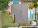 Aerial view of home showcasing the pool, landscaping, fenced backyard, and covered patio at 5264 Albion Rd, Venice, FL 34293