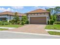 Beautiful home with tile roof and paver driveway; mature landscaping and a two-car garage enhance the curb appeal at 5856 Semolino St, Nokomis, FL 34275