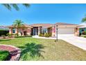 Beautiful single-story home with well-manicured lawn, mature trees, and a two-car garage at 5868 Jefferson Rd, Venice, FL 34293
