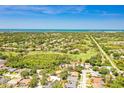 Stunning aerial view of the property showcasing the community, nearby golf course, and ocean views at 622 Pine Ranch East Rd, Osprey, FL 34229