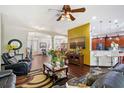 Open living room with hardwood floors, a television, and views into other living areas at 66 Statler St, Port Charlotte, FL 33954