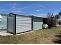 Side view of home with shed, offering extra storage and functionality at 6741 Laurel Ct, North Port, FL 34287