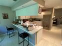 Bright kitchen featuring a breakfast bar and ample cabinet space; perfect for casual dining and entertaining at 7560 Fairway Woods Dr # 305, Sarasota, FL 34238