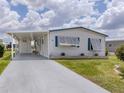 Charming single-story home with a covered carport and well-maintained landscaping at 798 Fairmount Dr, North Port, FL 34287