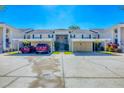 Inviting condo complex with covered parking, lush landscaping, and a well-maintained exterior in a convenient location at 819 Montrose Dr # 102, Venice, FL 34293