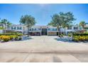 Well-maintained condo complex with mature trees providing shade and a welcoming atmosphere for residents and guests at 819 Montrose Dr # 102, Venice, FL 34293