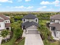 An aerial view of this home with two stories, beautiful landscaping, and a well-manicured front yard at 8304 Shooting Star Rd, Sarasota, FL 34241