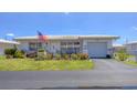 Lovely single-story home with an attached garage, American flag, and well-kept lawn at 8701 Pickwick Rd, North Port, FL 34287