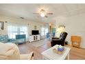 Bright living room with light colored walls, wood floors, ceiling fan and comfortable seating at 881 Grado Dr, Venice, FL 34285