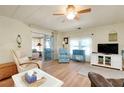 Inviting living room with wood floors, comfortable seating and an adjacent screened lanai at 881 Grado Dr, Venice, FL 34285