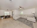Open concept living area featuring tile floors, a comfortable sectional sofa, and a dining space at 929 Cypress Ave, Venice, FL 34285