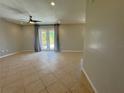 Spacious living room with tile flooring and sliding glass doors to the backyard at 98 Maltby St, Port Charlotte, FL 33953