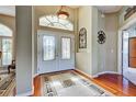 Elegant foyer with hardwood floors, decorative rug, and stylish lighting creating a grand entrance to this beautiful home at 1037 Beckley Cir, Venice, FL 34292