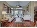 Bright living room with hardwood floors, neutral decor, and natural light creating a warm and inviting space at 1037 Beckley Cir, Venice, FL 34292